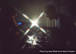 London, England, United Kingdom - Nov 9, 2022: Side view of man DJ-ing with flare 569xL0