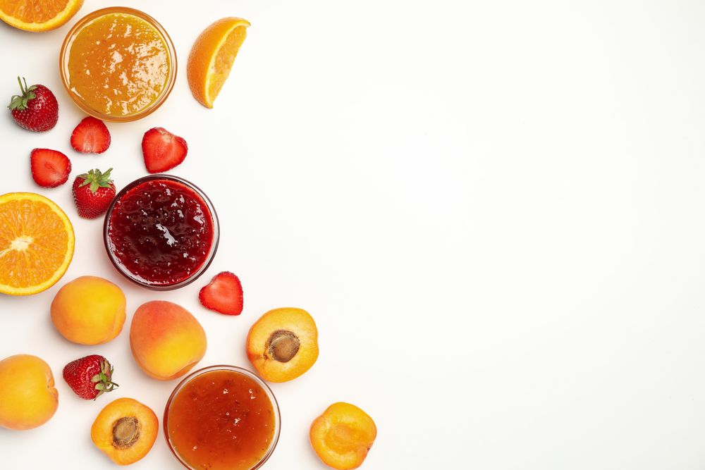 Composition with jam and ingredients on plain background, top view