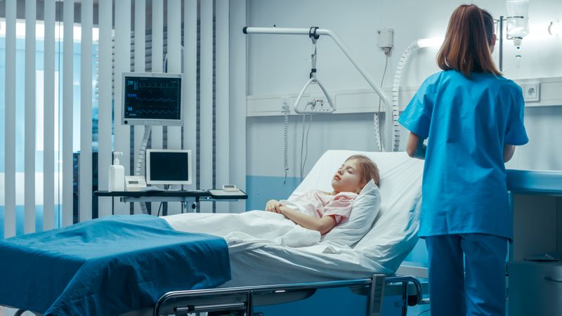 Sick Little Girl Lies on a Bed In the Hospital