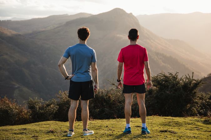 Male runners resting and enjoying mountain landscape