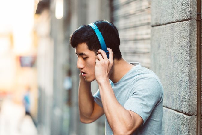Man in headphones listening music on the street