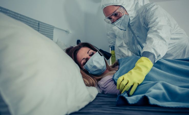 Woman in home quarantine for a virus attended by a doctor