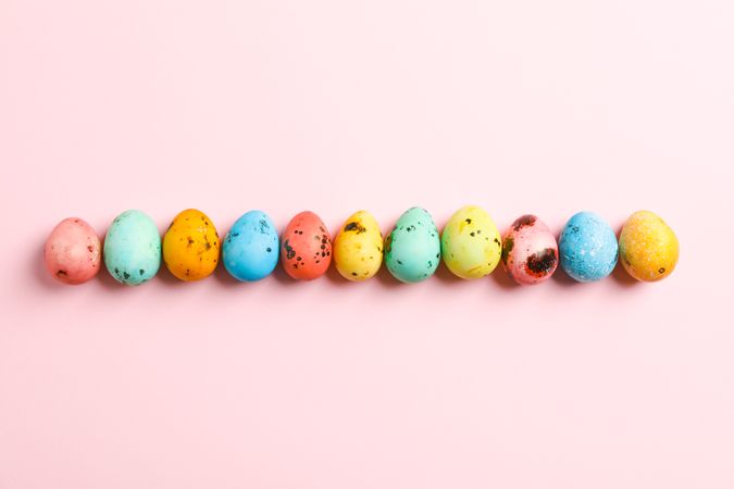 Decorative Easter eggs on color background, space for text. Top view