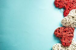 Thatched hearts on blue pastel background