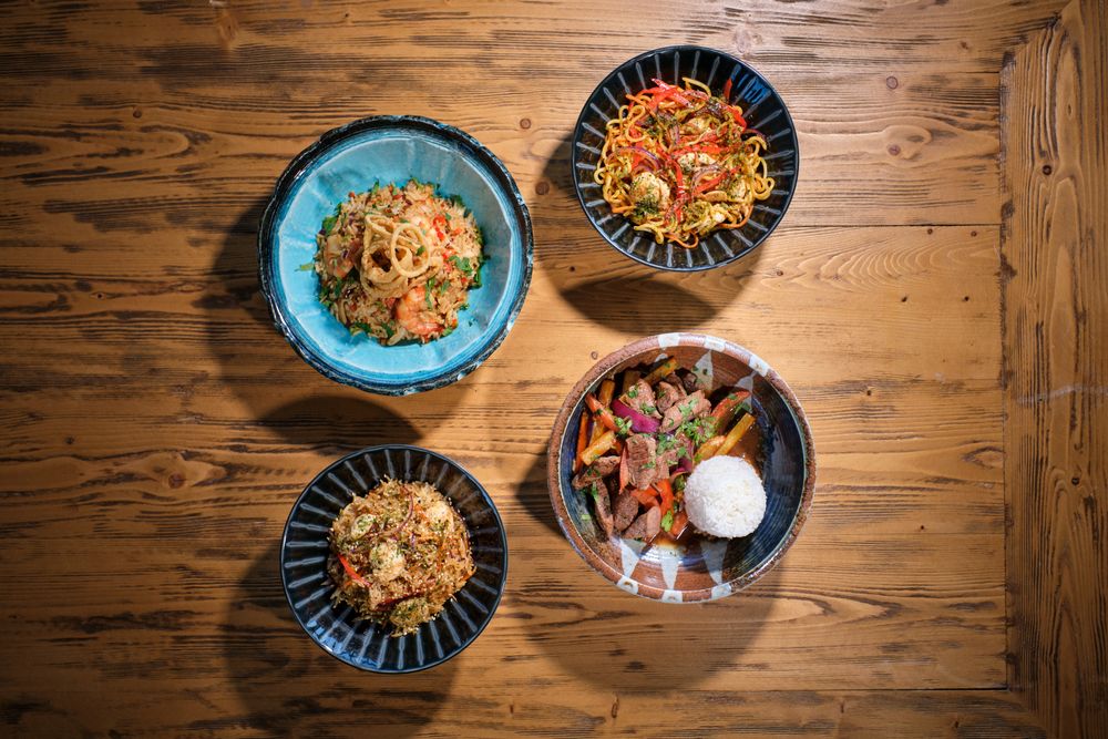 Appetizing dishes served in bowls on wooden table