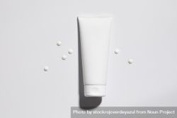 Mockup of plastic tube of cream with dots of product 5oDDJx