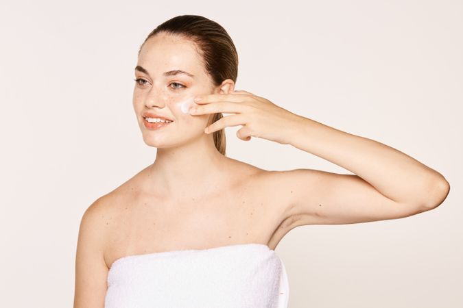 Amiable female taking care of face