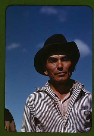 Hispanic man in a hat working outside in Texas