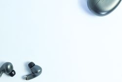 Top view of wireless earbuds on plain table with space for text
