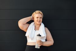 Curvy blond woman resting after a workout