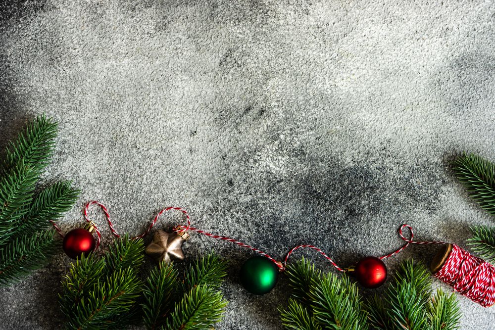Christmas frame with branches on stone background