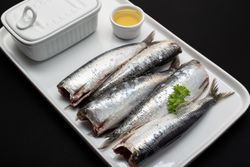 Raw fish without heads on plate