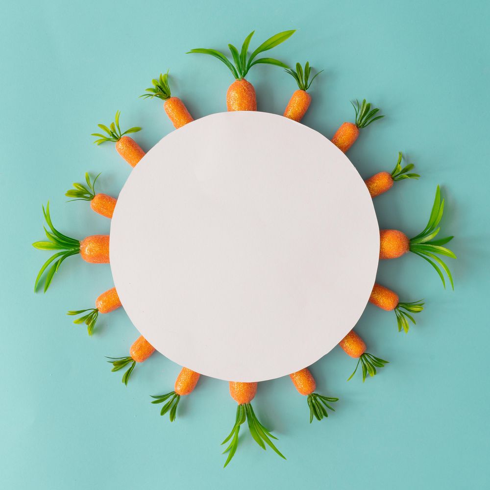 Creative composition made with carrots and paper card copy space
