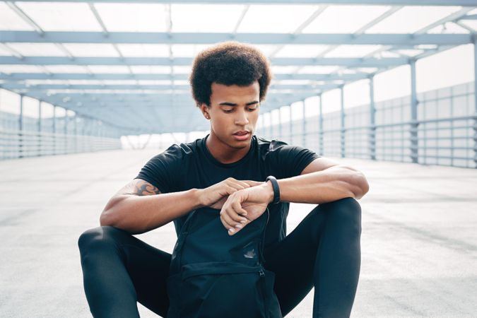 Male athlete checking smart watch after training