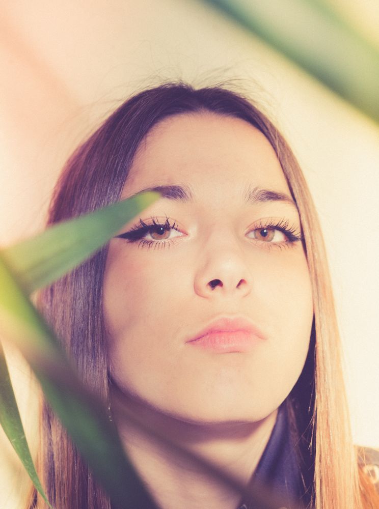 Woman between green leaves