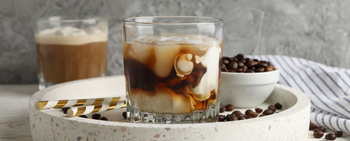 Composition with ice coffee on wooden background, close up
