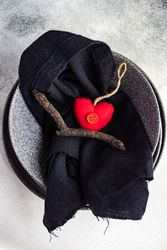 Top view of Valentine table setting with red felt heart