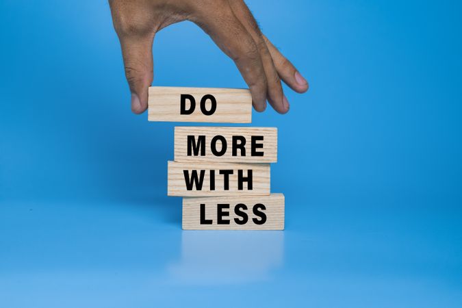 do more with less words on wooden blocks
