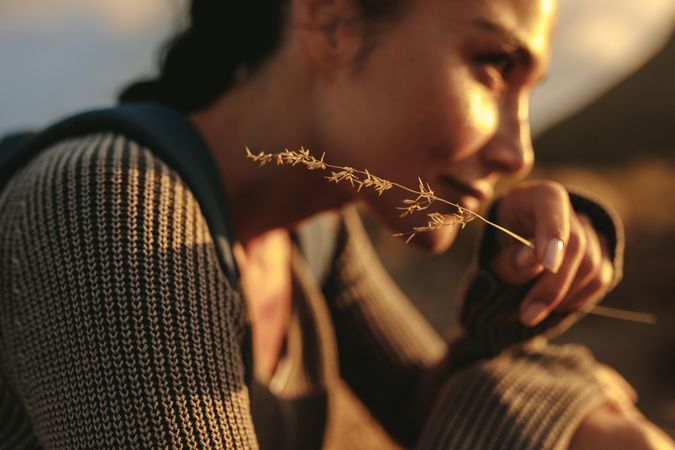Close up of a woman hiker holding a twig