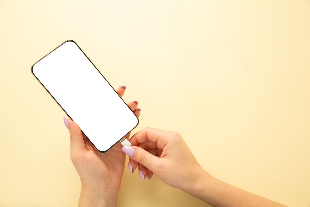 Woman Charging Smartphone on Yellow