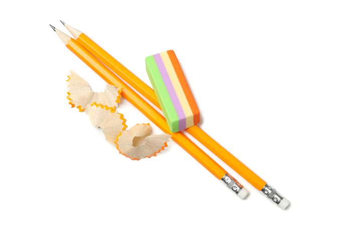 Freshly sharpened pencils with eraser on plain background