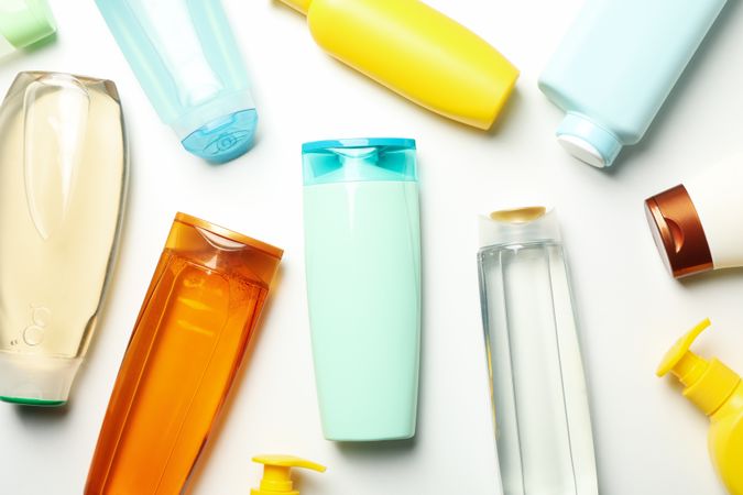 Blank bottles of cosmetics on light background