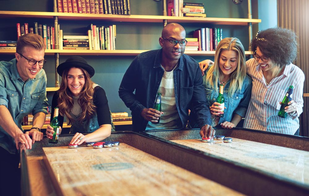 Multi-ethnic group of friends playing a bar game