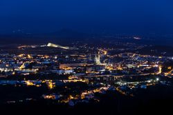 Scenic night cityscape with illuminated buildings and streets
