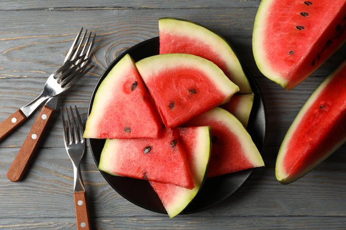 Composition with watermelon slices on gray wooden table. Summer fruit