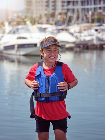 Smiling boy in safety vest looking at camera