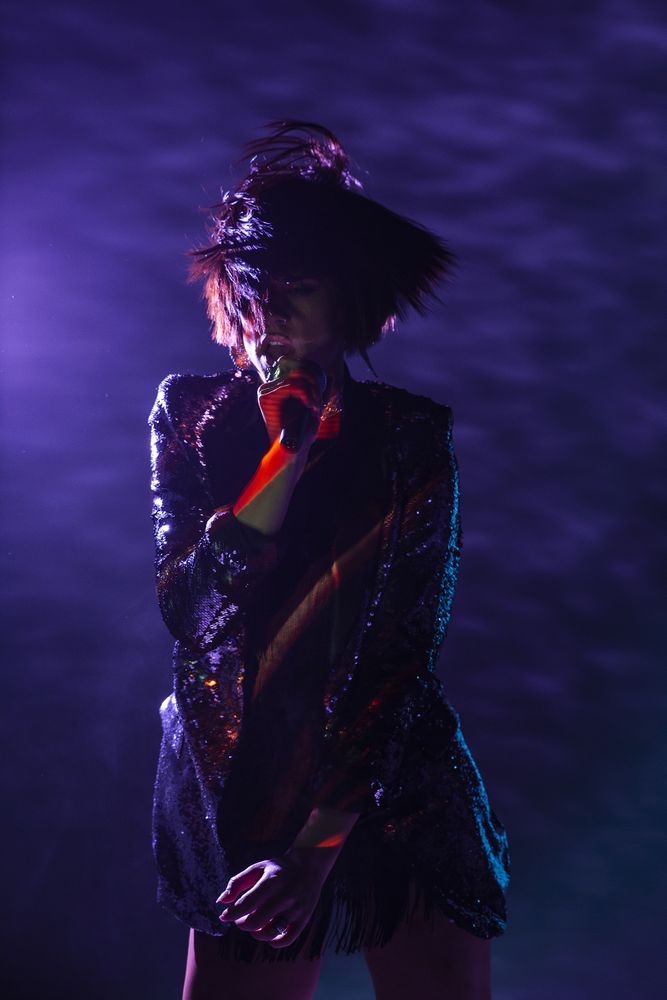 Stylish woman singing on stage