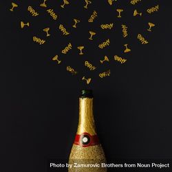Golden champagne party bottle on background with gold confetti 5ajgo4