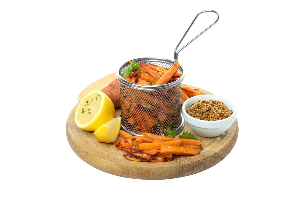 fried sweet potato in friture on a board, isolated on light background