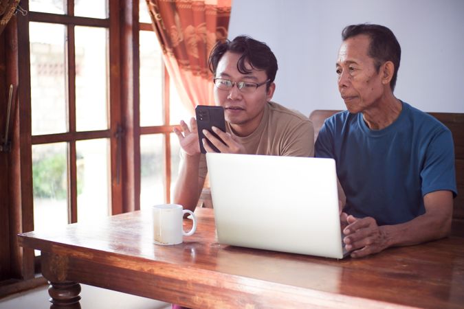 Father and son with laptop
