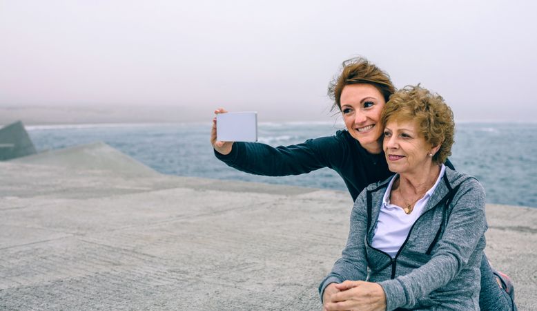 Trainer taking selfie with Older woman