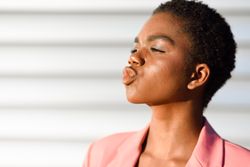Side view of female making kissing face