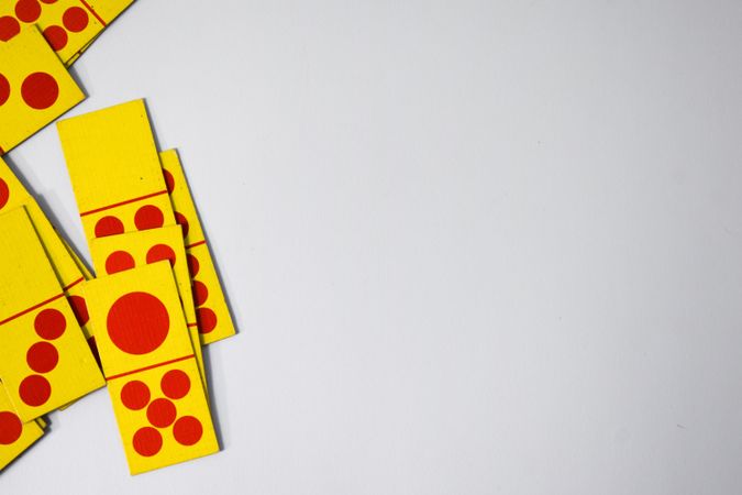 Top view of red and yellow domino cards with copy space