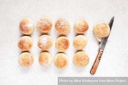 Freshly baked bread rolls with knife bEMgGb