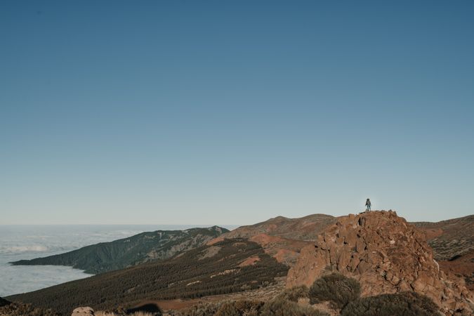 Tourist standing on top of hill