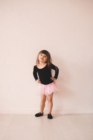 Cute baby girl wear gymnastic leotard and dance shoes