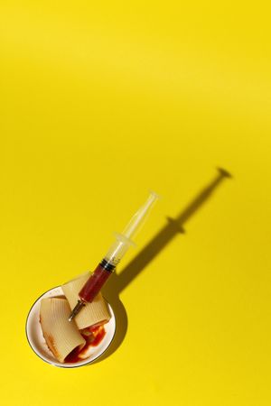 Stuffed pasta with red sauce in syringe