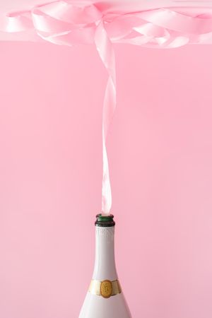 Champagne bottle with pink party ribbon