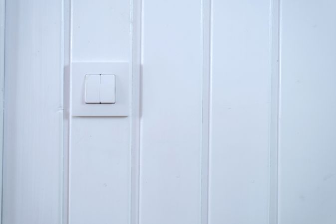 Light switch on wood pannelled wall