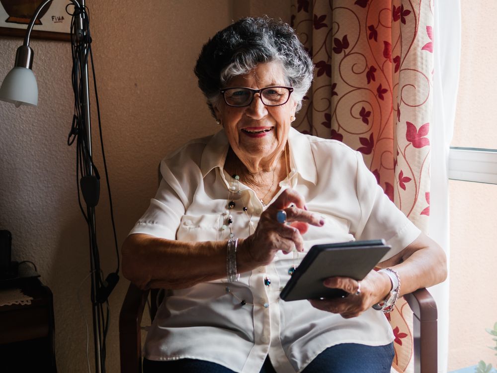 Mature female reading e-book at home