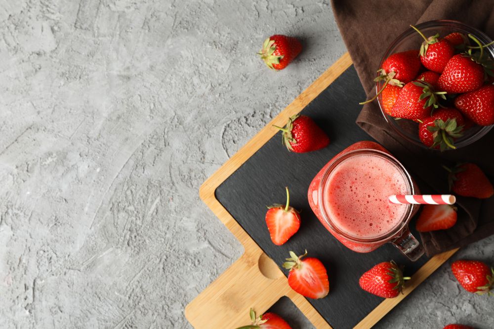 Composition with strawberry cocktail on gray table. Summer berry