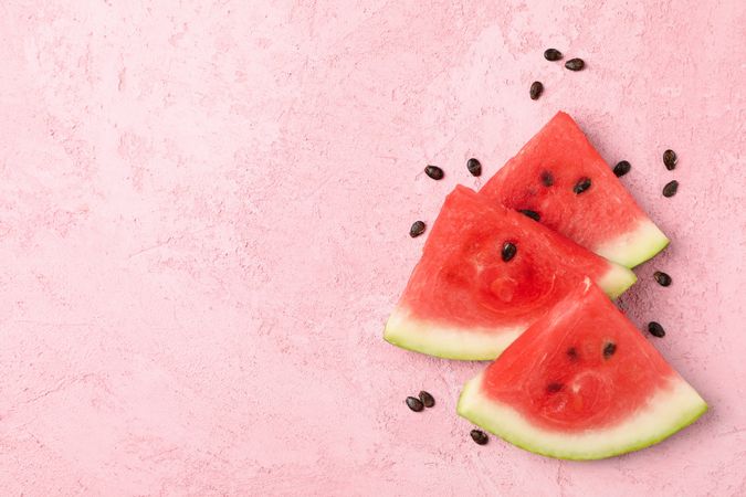 Composition with watermelon slices on pink background, top view