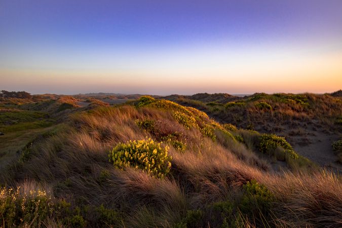 Colorful sunset on top of rolling hills