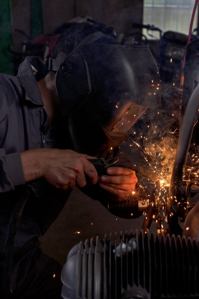 Experienced man working in custom made motorcycle workshop
