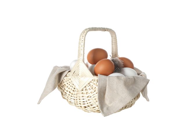eggs in a wicker basket with handles, isolated on blank background.