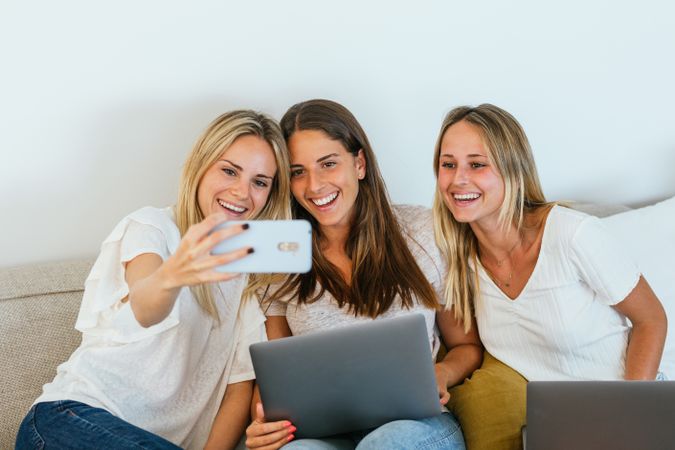 Woman taking a selfie with her sisters